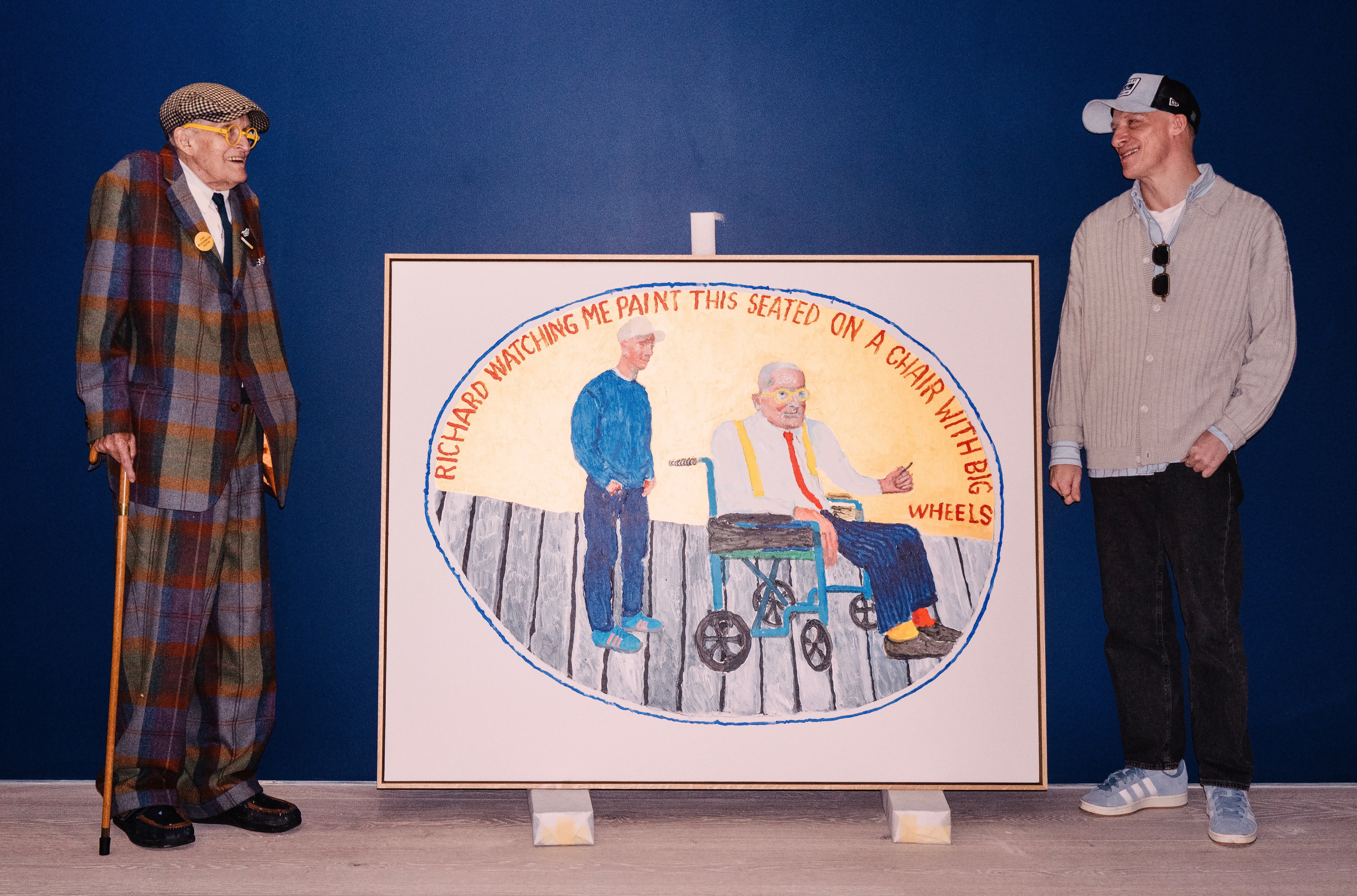 David Hockney and Richard Hockney next to a painting from the "Moon Room" series at Annely Juda Fine Art.