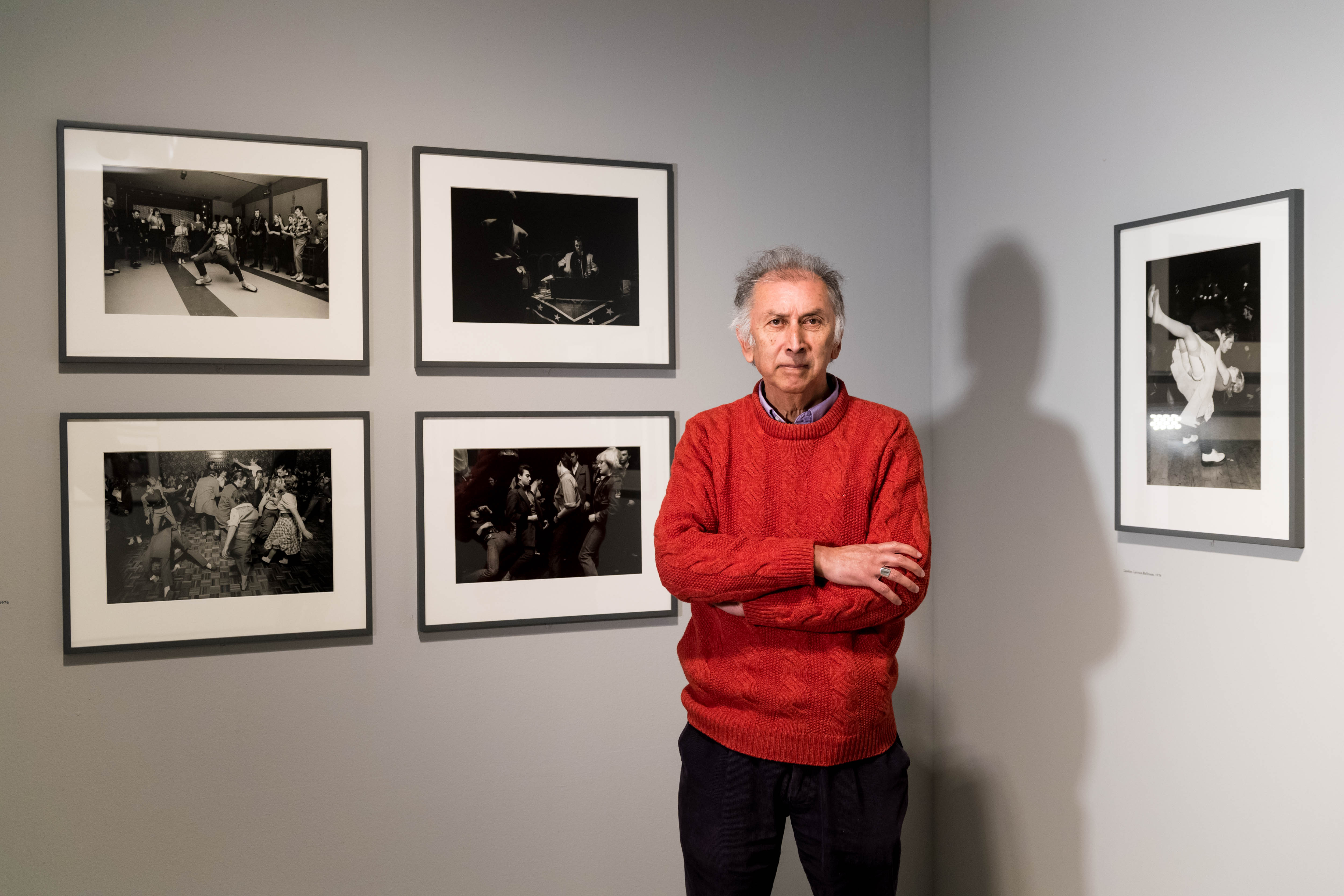 Photographer Chris Steele-Perkins poses in the exhibition space "Another Kind of Life: Photography on the Margins" at the Barbican Art Gallery.