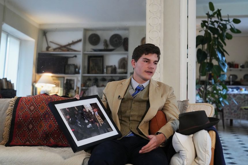 Pedro Elias Garzon Delvaux holds an Associated Press photo of him taken outside the Louvre on the day of the crown jewels heist in Rambouillet, south of Paris.