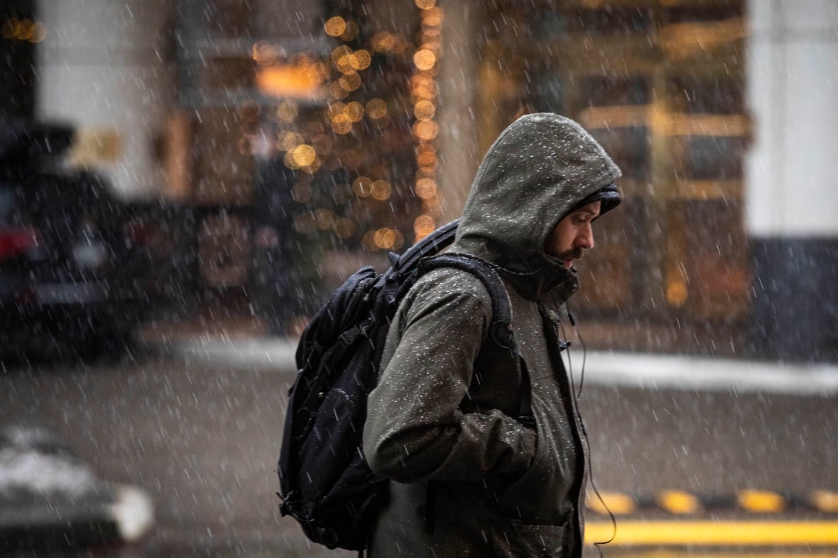 A person walks on the streets of Vancouver during a snowfall on Jan. 4, 2022.