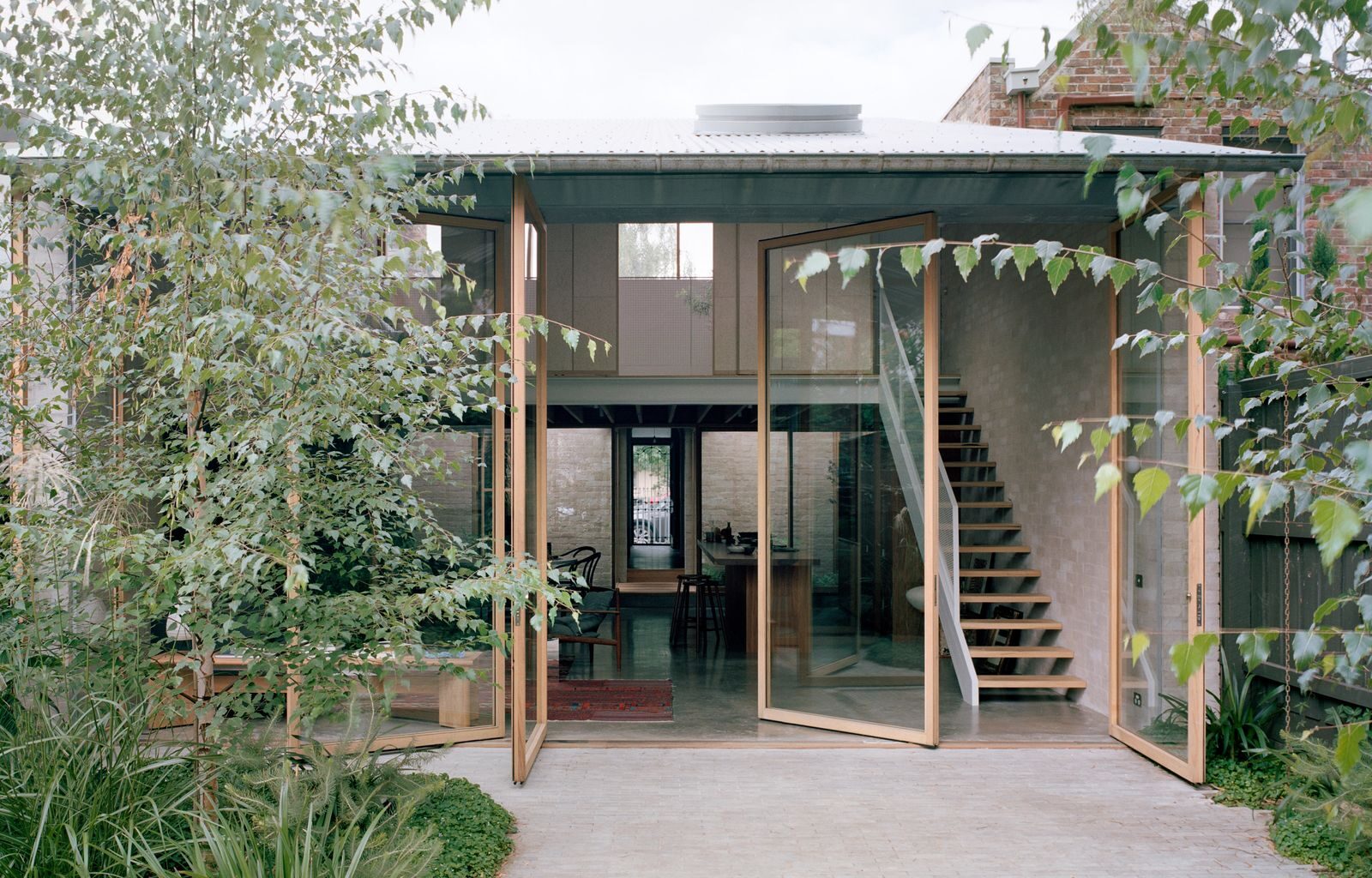 Four Massive Pivot Doors Bring the Outdoors In at This Australian Family Home