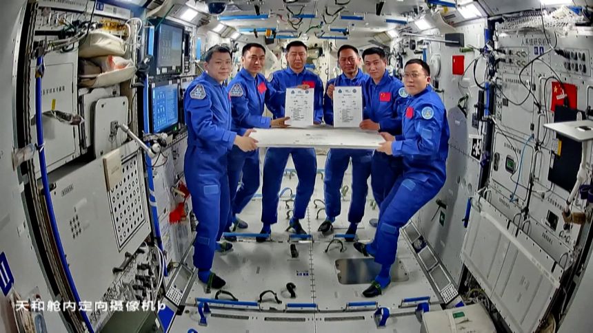 Crew members of Shenzhou-20 and Shenzhou-21 signing documents for work handover on board the Tiangong space station on November 4, 2025.