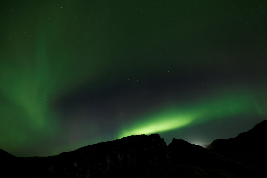 Northern Lights, also called aurora borealis, illuminate the night sky near the town of Thorlakshofn