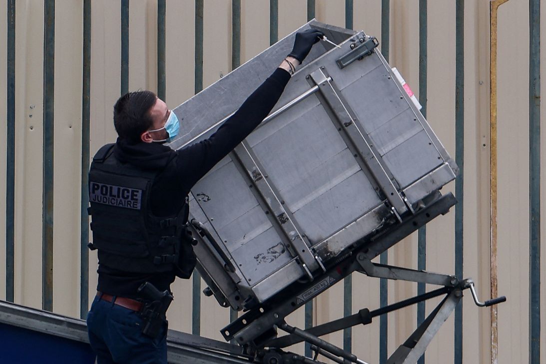 A police officer examines the lift used to steal jewels from the Louvre.