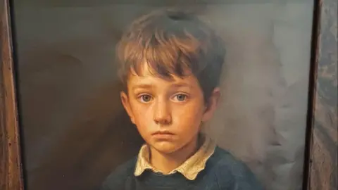 A close up of the school boy's face from the digital print. 