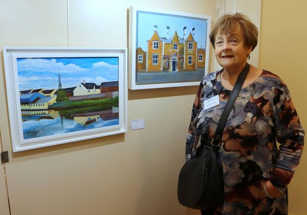 Artist Ruth Coffey in front of her work