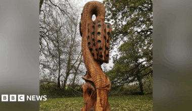 The wooden sculpture depicting a snake's head fritillary.