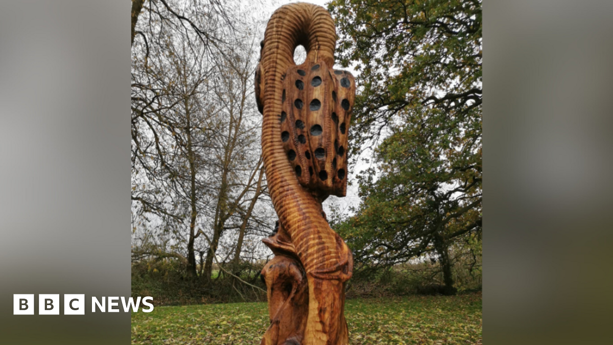 The wooden sculpture depicting a snake's head fritillary.