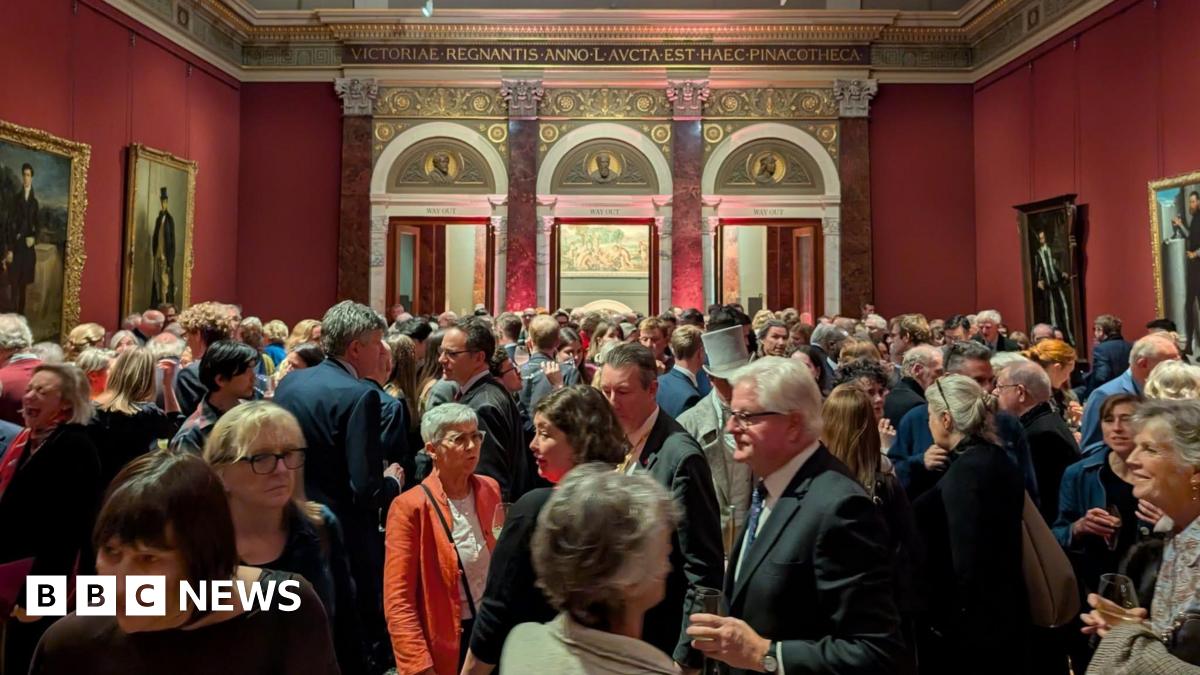A woman takes a picture of two of Joseph Wright of Derby's pieces at a previous exhibition