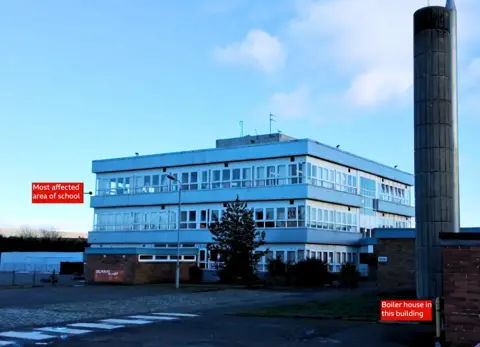 BBC Picture of three storey building that is a primary school with a boiler house and chimney also visible