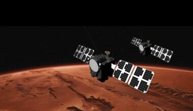 An illustration showing two large satellites with solar arrays on either side floating above the reddish-brownish surface of Mars.