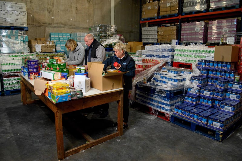 Volunteers Kate Durrant, John Connolly  and Annette Butler prepare food boxes for delivery from a St Vincent de Paul food bank in Cork city. Photograph: Daragh McSweeney/Provision