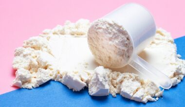 A spilled scoop of protein powder over a colourful background