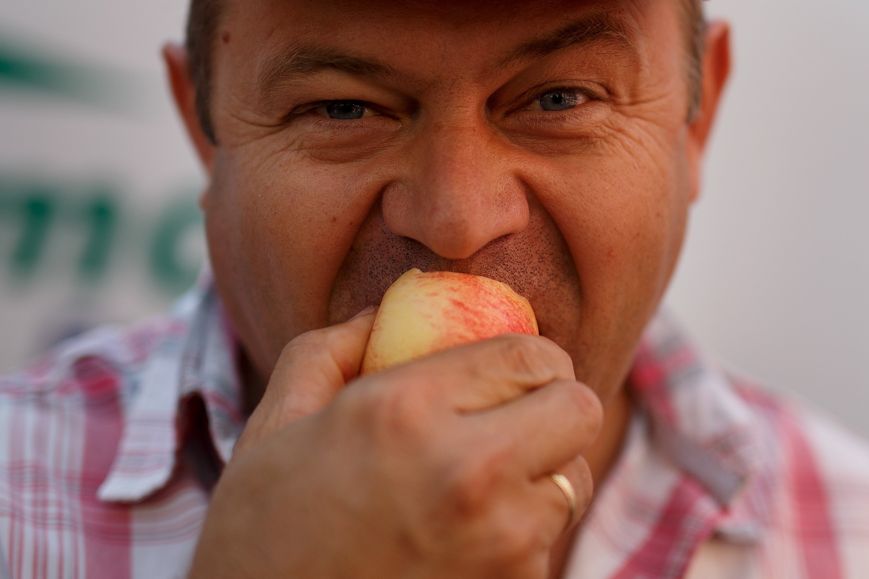 A farmer eats an apple in Madrid, Spain, in September 2014. Apples are another prebiotic fiber-rich fruit