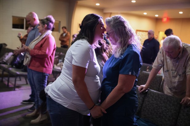 Jesika Quintal, right, prays with Kelly Hernandez at Lighthouse Christian Church in Sonoma on Wednesday, Oct. 15, 2025. (Christopher Chung/The Press Democrat)