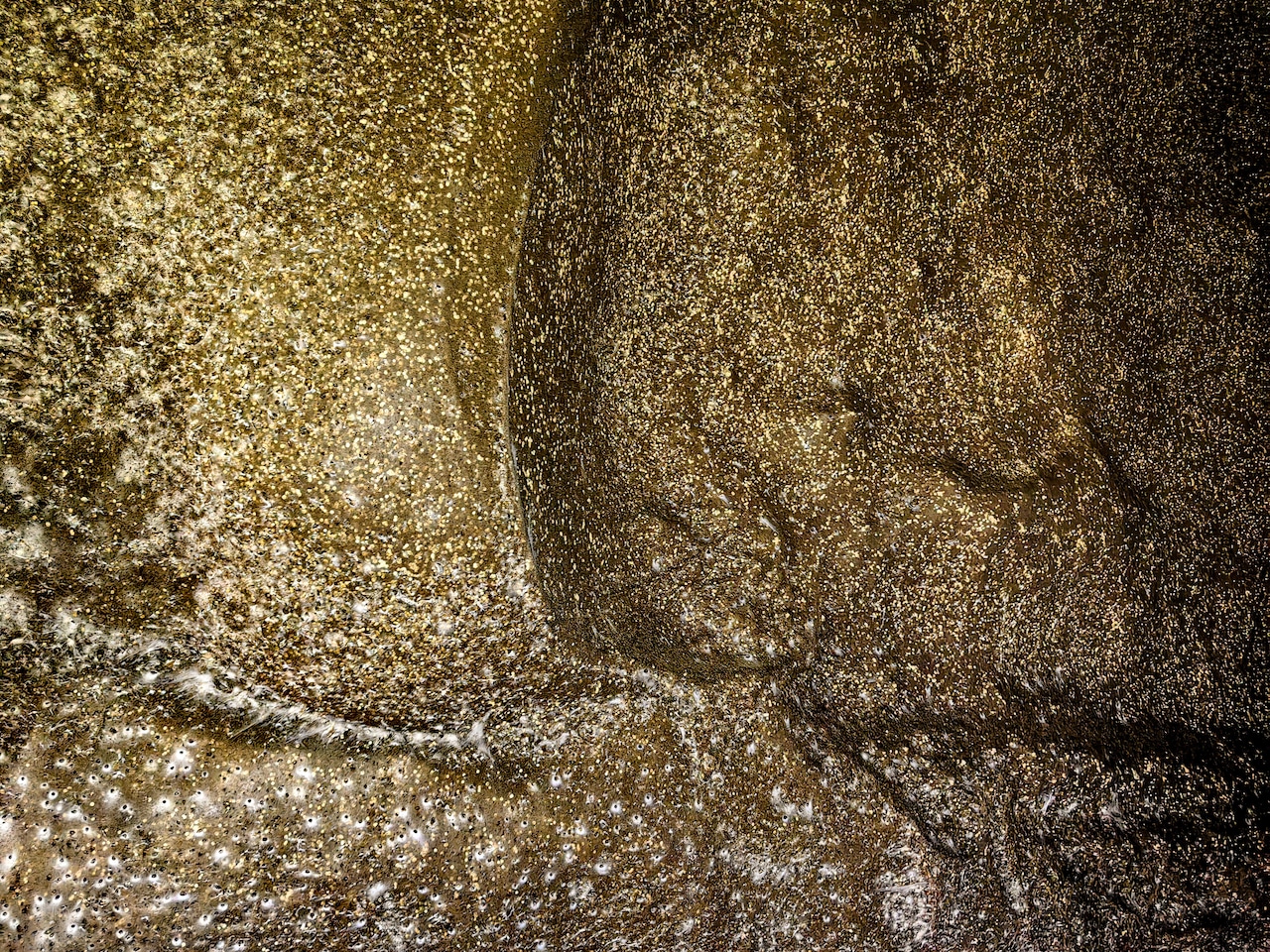 A wall with illuminated spots.