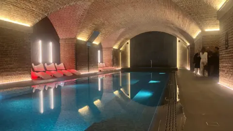 Photograph of the swimming pool underneath the former Manchester Central station. The images also shows the Victorian railway arches.