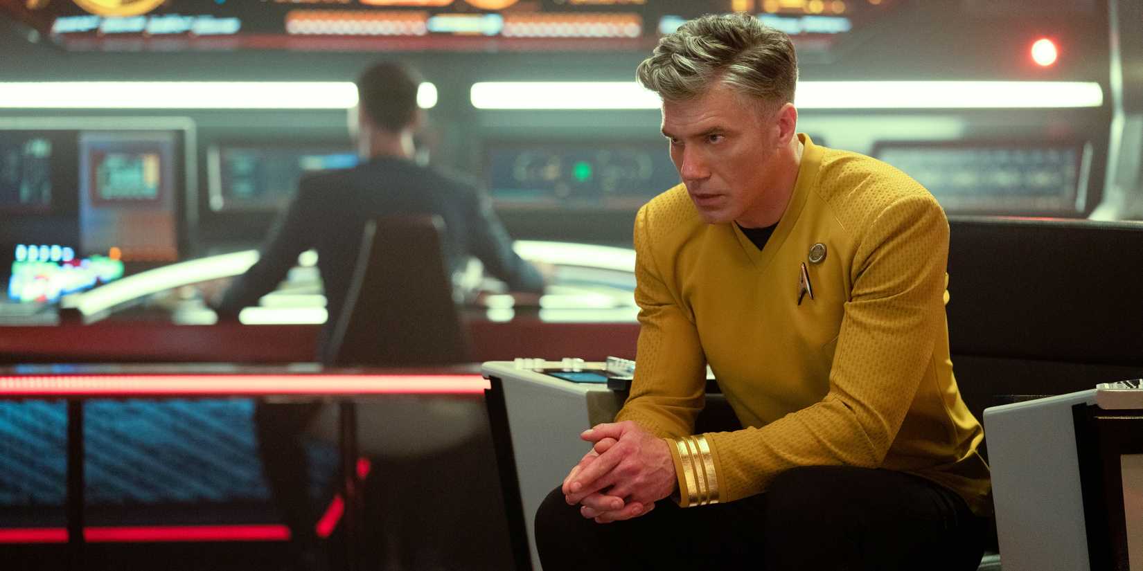 Captain Pike in the chair on the bridge with Spock in the background from Star Trek Strange New Worlds