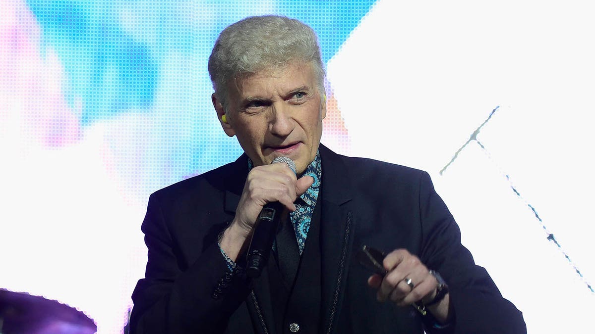 Dennis DeYong performing on stage 
