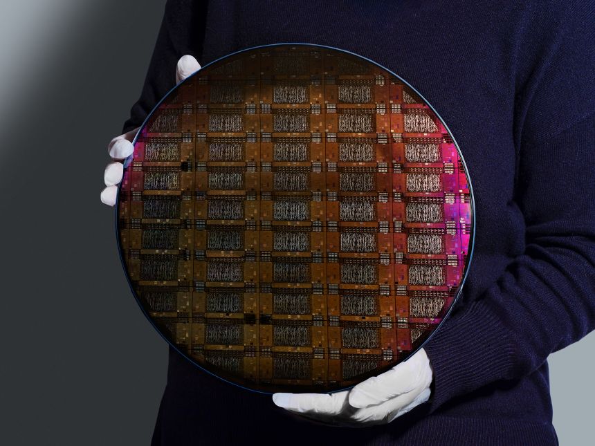 An IBM researcher holds the wafer, or the slice of silicon used to create processors and chips, for the company’s Loon experimental quantum processor.
