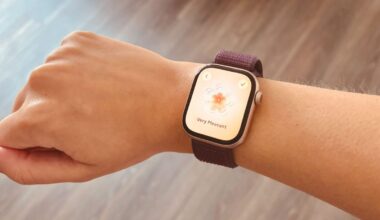 A hand with an Apple Watch 10 on it showing the State of Mind feature over a wood floor.