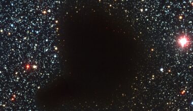 a photograph of starry outer space with a dark blob in the middle