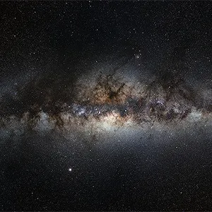This 360-degree panoramic image reveals the plane of our Milky Way Galaxy edge-on from our perspective on Earth, and provides an almost “outside looking in” view of its disk, and central bulge. Scientists have, for the first time ever, successfully observed a mid-IR flare in Sgr A*, the supermassive black hole that resides at the heart of the Milky Way. Credit: ESO, S. Brunier