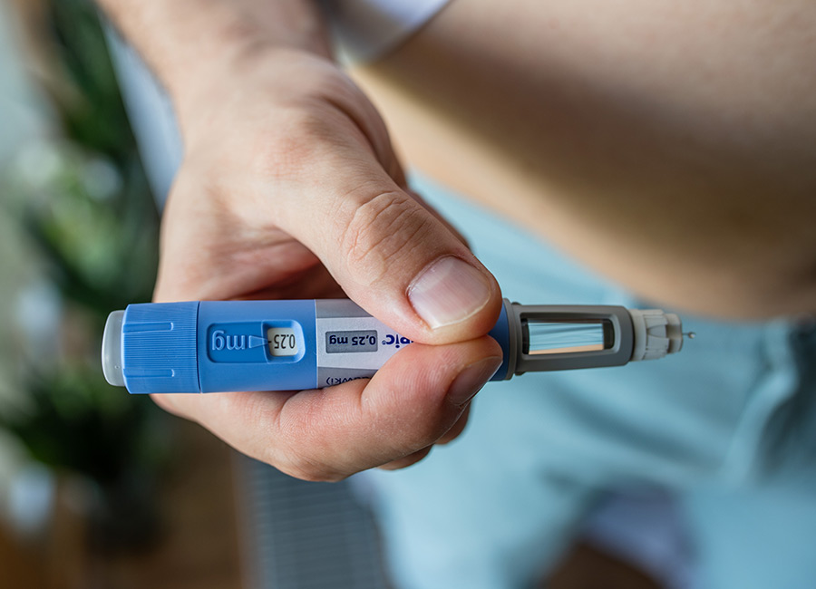 GDANSK, POLAND - MAY 2022: obese fat man preparing Semaglutide Ozempic injection control blood sugar levels