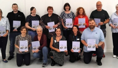 Group of people posing with training awards.