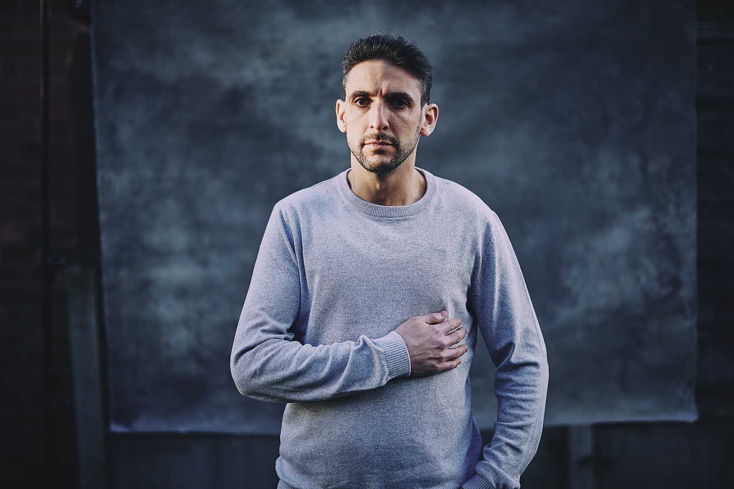 Yoni Finlay, who was injured in the Manchester synagogue attack, wearing a light-colored sweater with one hand placed over his chest.