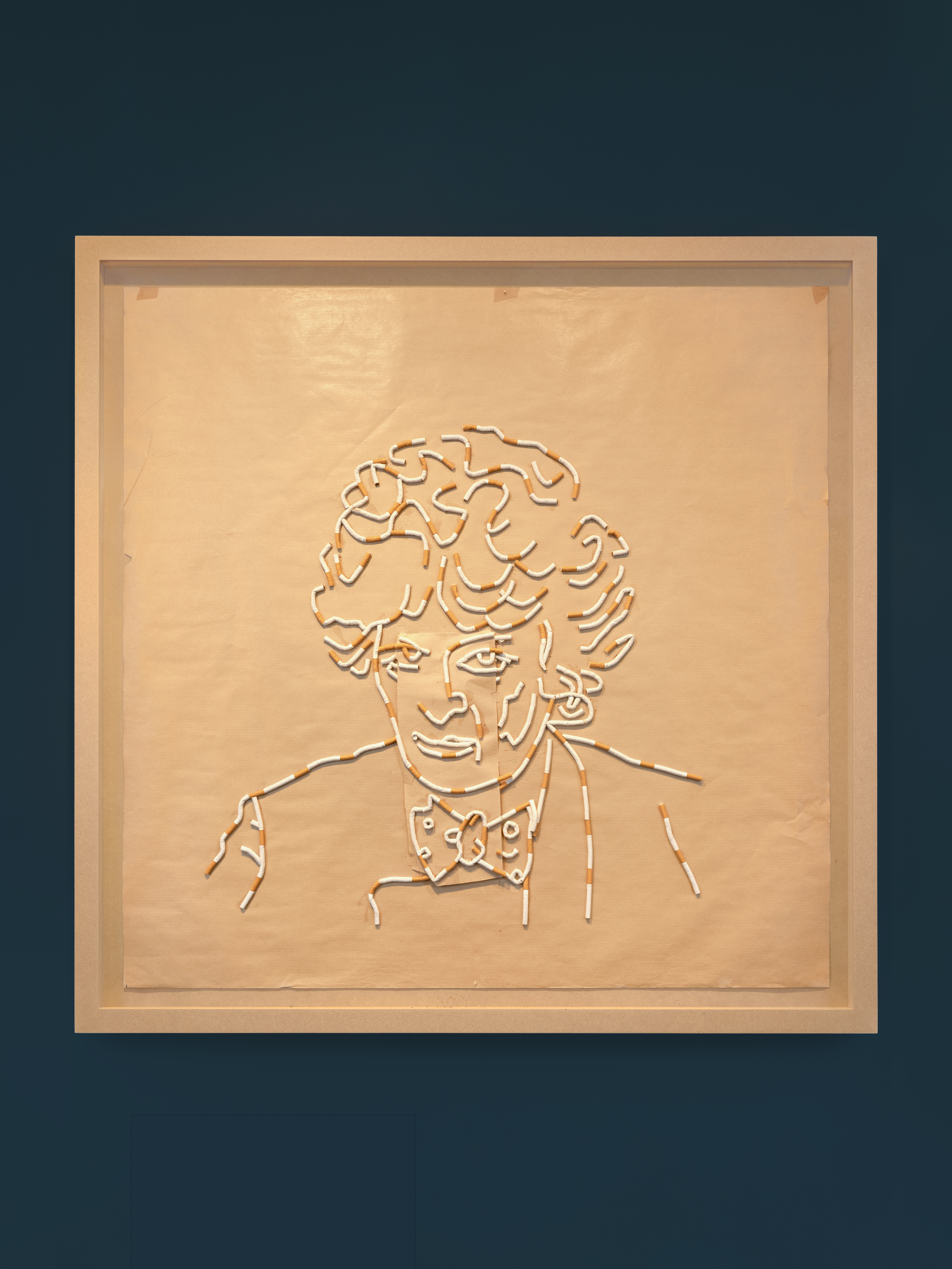 Sarah Lucas's "Maggi the Maggi" composed of brown paper, cigarettes, and MDF frame.