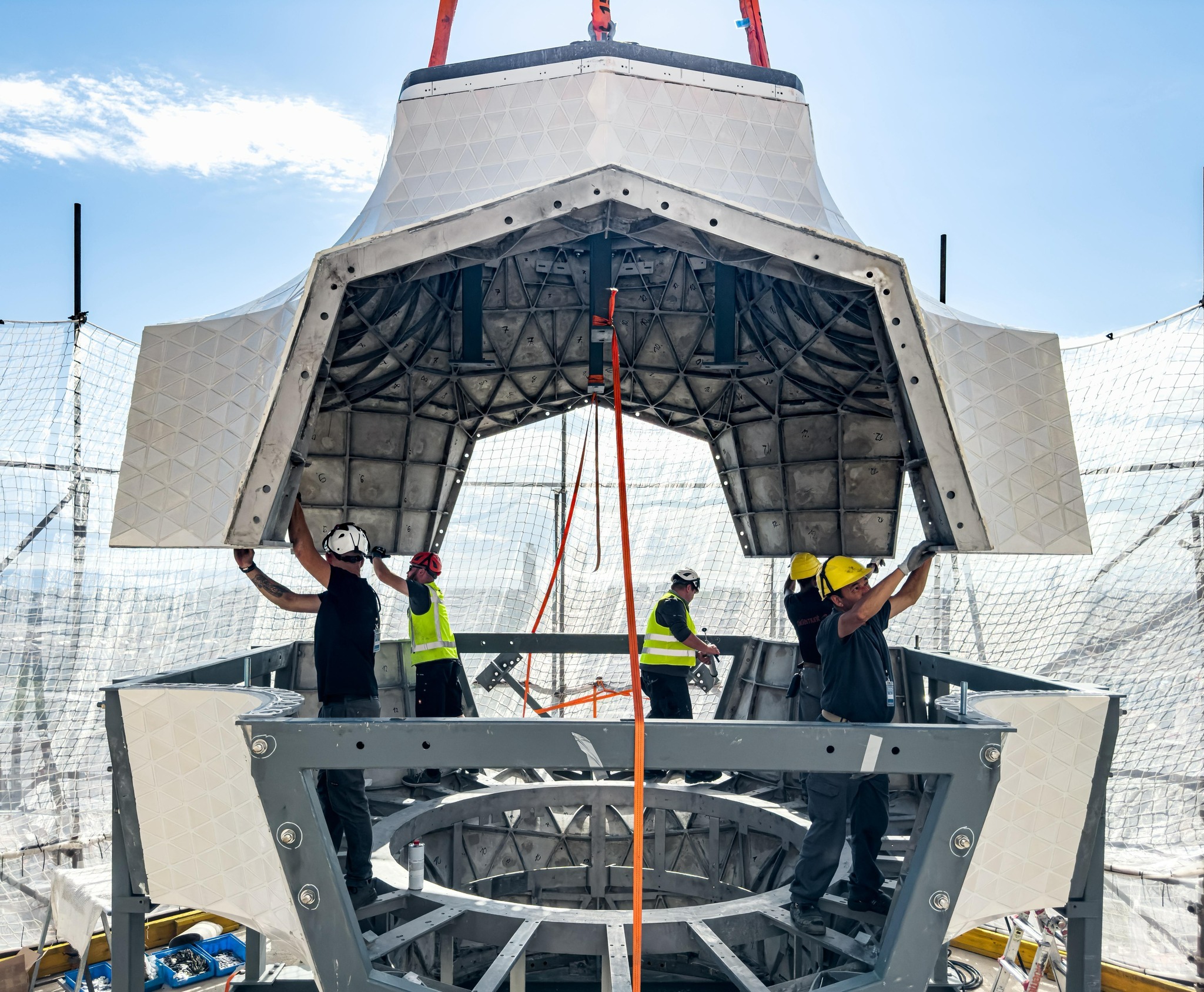 Construction workers assembling pieces of the core for the tower of Jesus Christ at Sagrada Familia.
