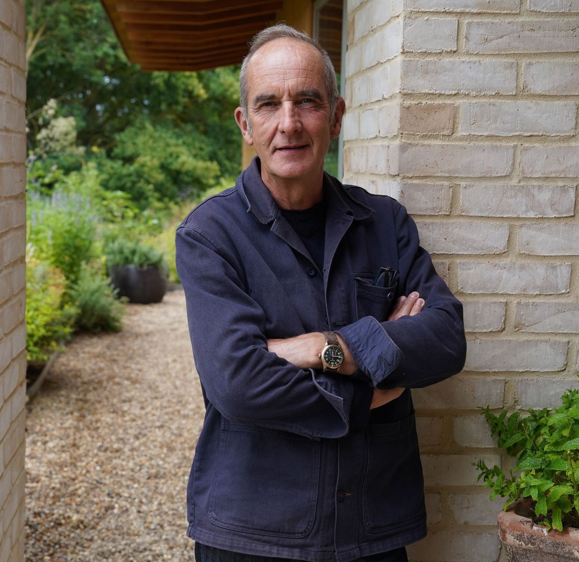 Kevin McCloud in a doorway.
