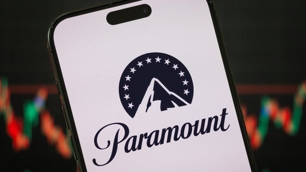 CHONGQING, CHINA - FEBRUARY 23: In this photo illustration, the Paramount logo is displayed on a smartphone screen, with the company's latest stock market performance and candlestick charts visible in the background, highlighting Paramount's real-time financial trends, stock price fluctuations, mark