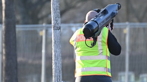 A policeman holds an anti-drone cannon near the chancellery in Berlin