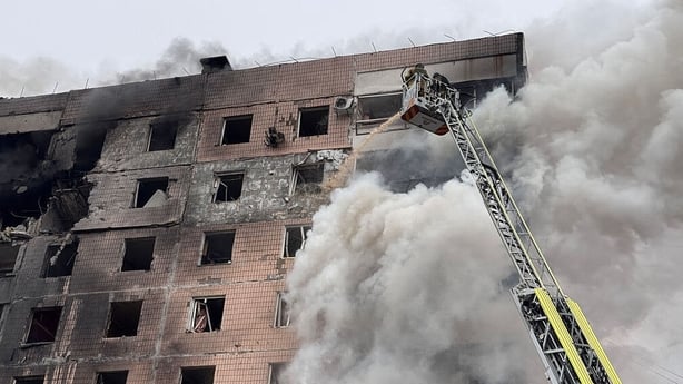 Ukrainian rescuers work to extinguish a fire in a damaged residential building following an air attack in Zaporizhzhia
