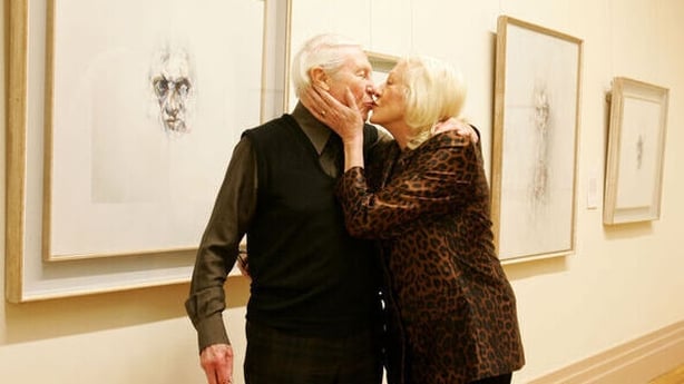 Photo shows artist Louis le Brocquy with his wife artist Anne Madden as they share a kiss