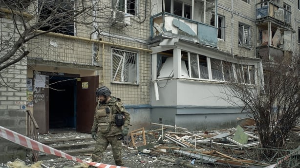 Explosive ordnance disposal specialists work alongside police officers to search for and collect debris in Kyiv, Ukraine