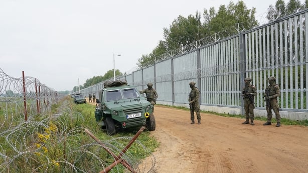 Polish border guards at the border fence with Belarus