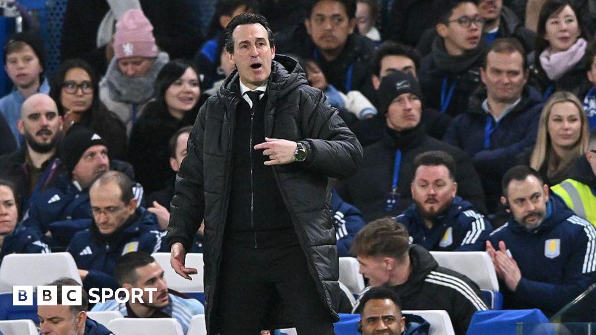 Unai Emery pointing and shouting while in the dugout in front of Aston Villa's bench at Stamford Bridge