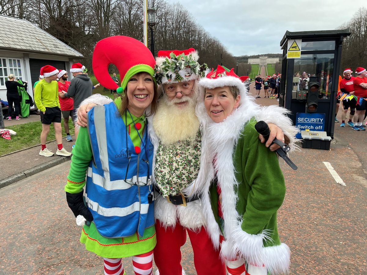 (left to right) Parkrun race director Marianne Hood, Jimmy McNeill with his wife Una McNeill at the festive themed Christmas Day Parkrun at Stormont in Belfast. 