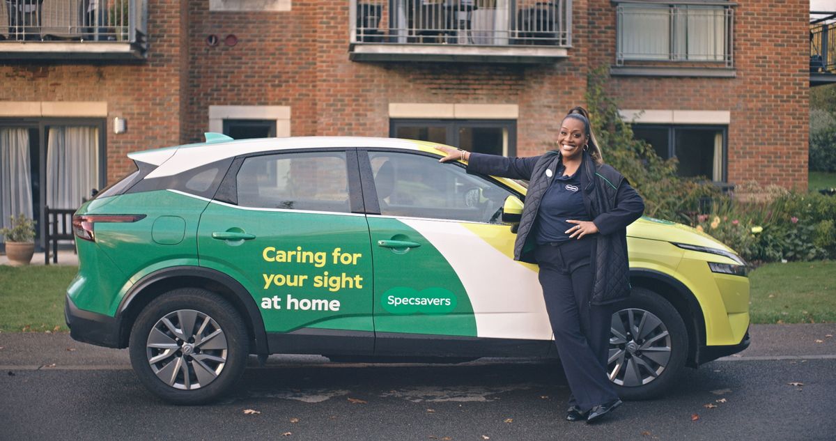 Alison Hammond beside a car