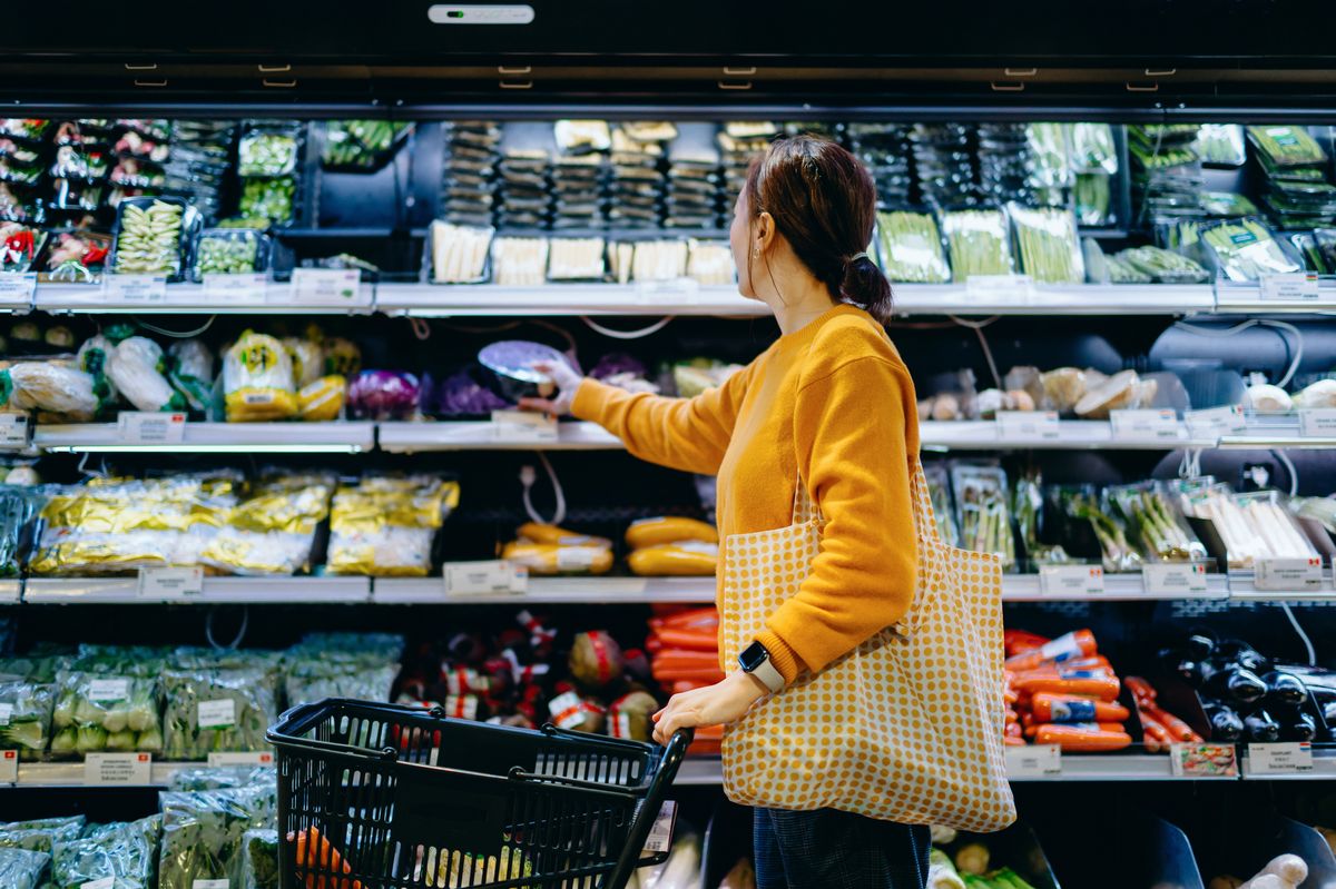 Woman in supermarket stock photo