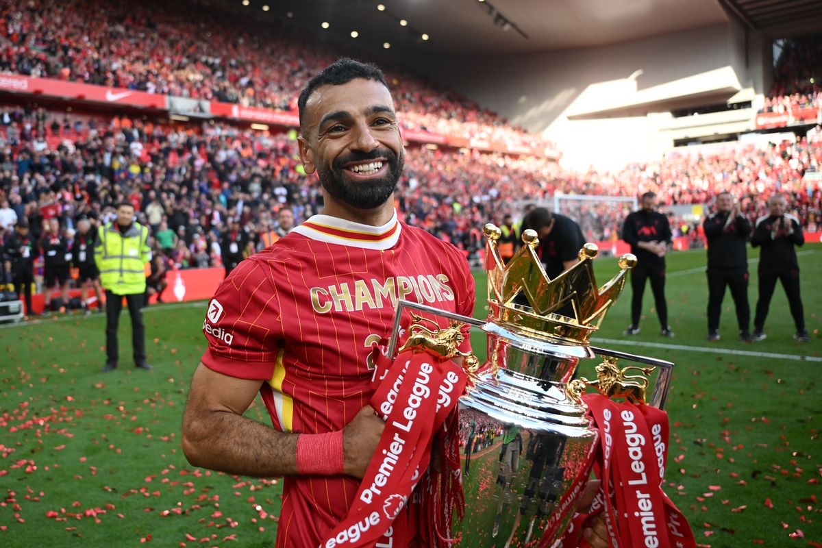 Mohamed Salah of Liverpool  celebrates with the Premier League trophy trophy, as Liverpool are crowned the Champions of the Premier League for the 2024/25 Season, following the Premier League match between Liverpool FC and Crystal Palace FC at Anfield on May 25, 2025 in Liverpool, England. 