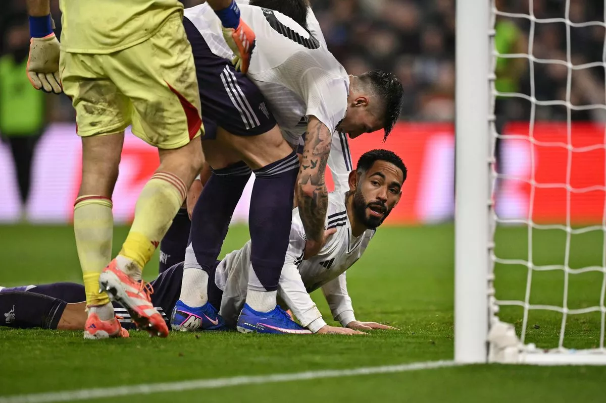 Manchester United forward Matheus Cunha is picked up by his teammates after missing a close chance vs Aston Villa