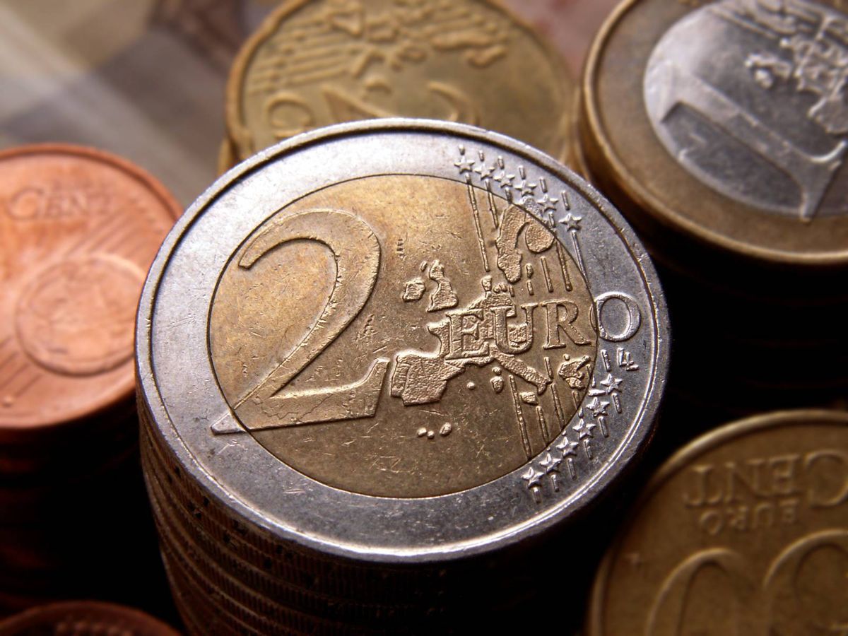 Two Euro coin in front of other coins