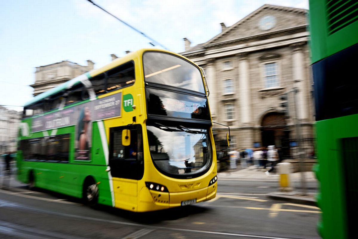 A Transport for Ireland (TFI) bus is driven past Trinity College in Dublin on September 15, 2024. (Photo by Paul ELLIS / AFP) (Photo by PAUL ELLIS/AFP via Getty Images)