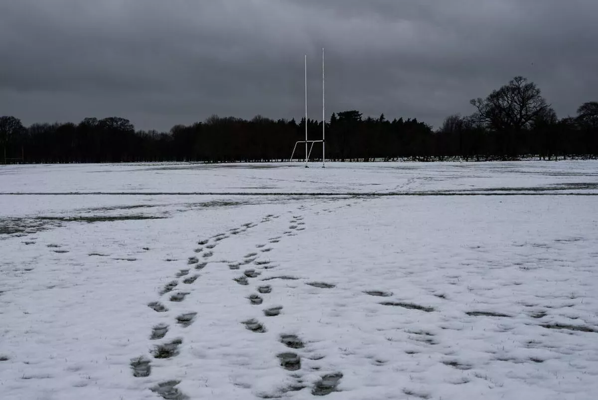 DUBLIN, IRELAND - MARCH 2: Footprints on the snowy foreground can be seen, and a Gaelic football goal posts in the background, on March 2, 2024 in Dublin, Ireland.  Following heavy snowfall across Ireland, a Status Yellow ice warning is in effect with temperatures expected to drop as low as -1 degree according to Met Éireann. (Photo by Natalia Campos/Getty Images)