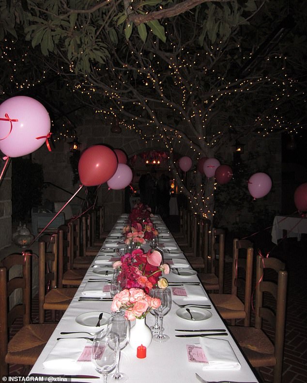 Guests dined outside on a beautifully decorated table and beneath magical white lights