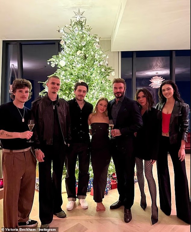 Pictured last year: Brooklyn and Nicola pose with David, Victoria, Harper, Cruz and Romeo at their stunning Christmas tree
